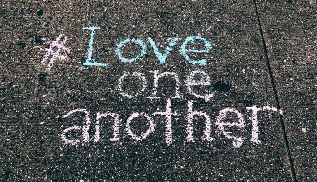 #ILoveOneAnother chalk art demonstrating God’s love and sharing faith from a distance.