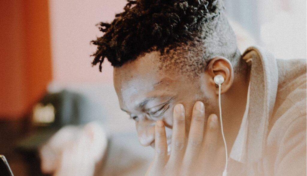 Man listening to Christian leadership podcasts with earbuds.