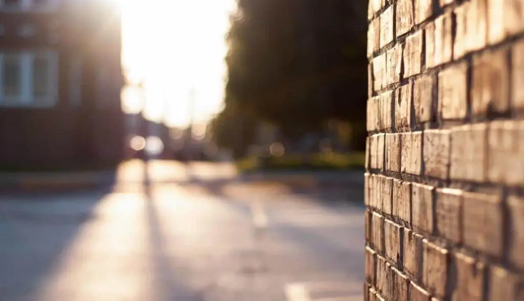 Brick wall and sunlight symbolizing faith and trust during difficult times.