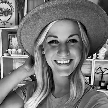 Trisha Baumhardt, Everyday Faith Podcast guest, smiling and wearing a hat.