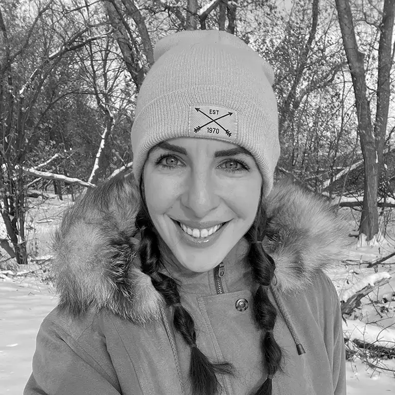 Carissa Krey, podcast guest, smiling in winter coat and hat