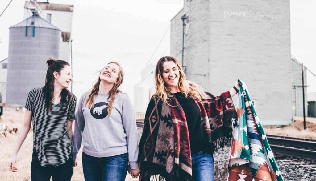 Three women walking and sharing God’s love and joy.