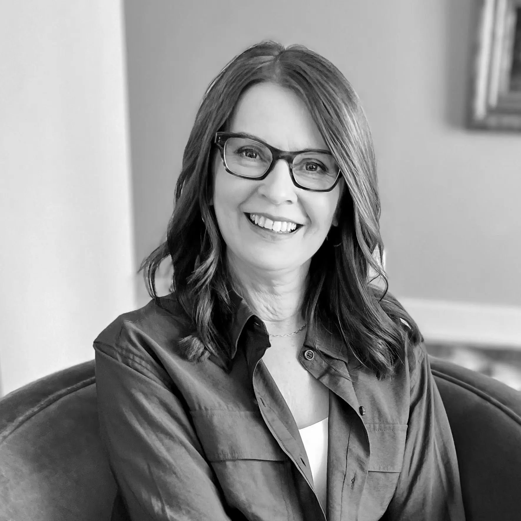 Jeannie Baron, guest on the Ask About My Faith podcast, smiling and wearing glasses