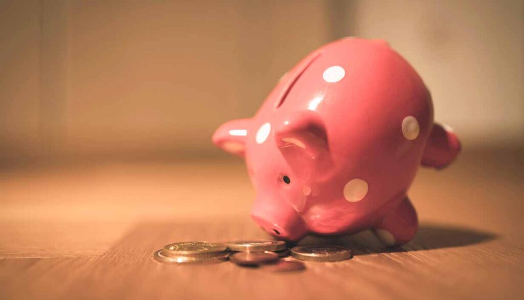 Pink piggy bank and coins representing financial stress and Bible verses for peace of mind.