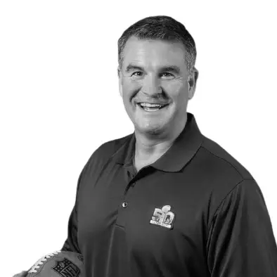 Darrin Gray, Ask About My Faith podcast guest, smiling and holding a football