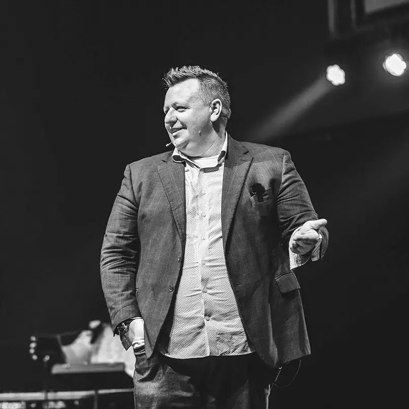 Dean Goossen speaking on stage, Everyday Faith Podcast guest and pillar of belief.