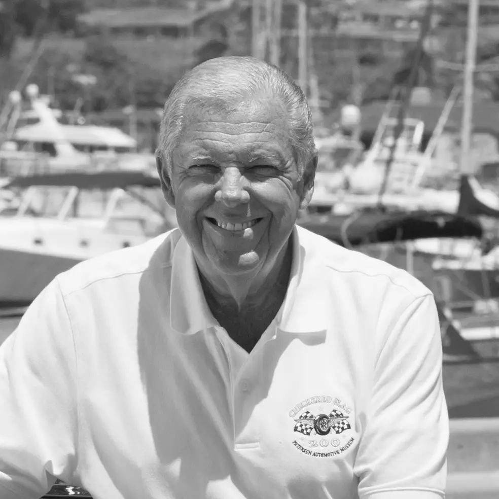 Barry Meguiar, podcast guest, smiling and wearing a polo shirt with automotive museum logo.