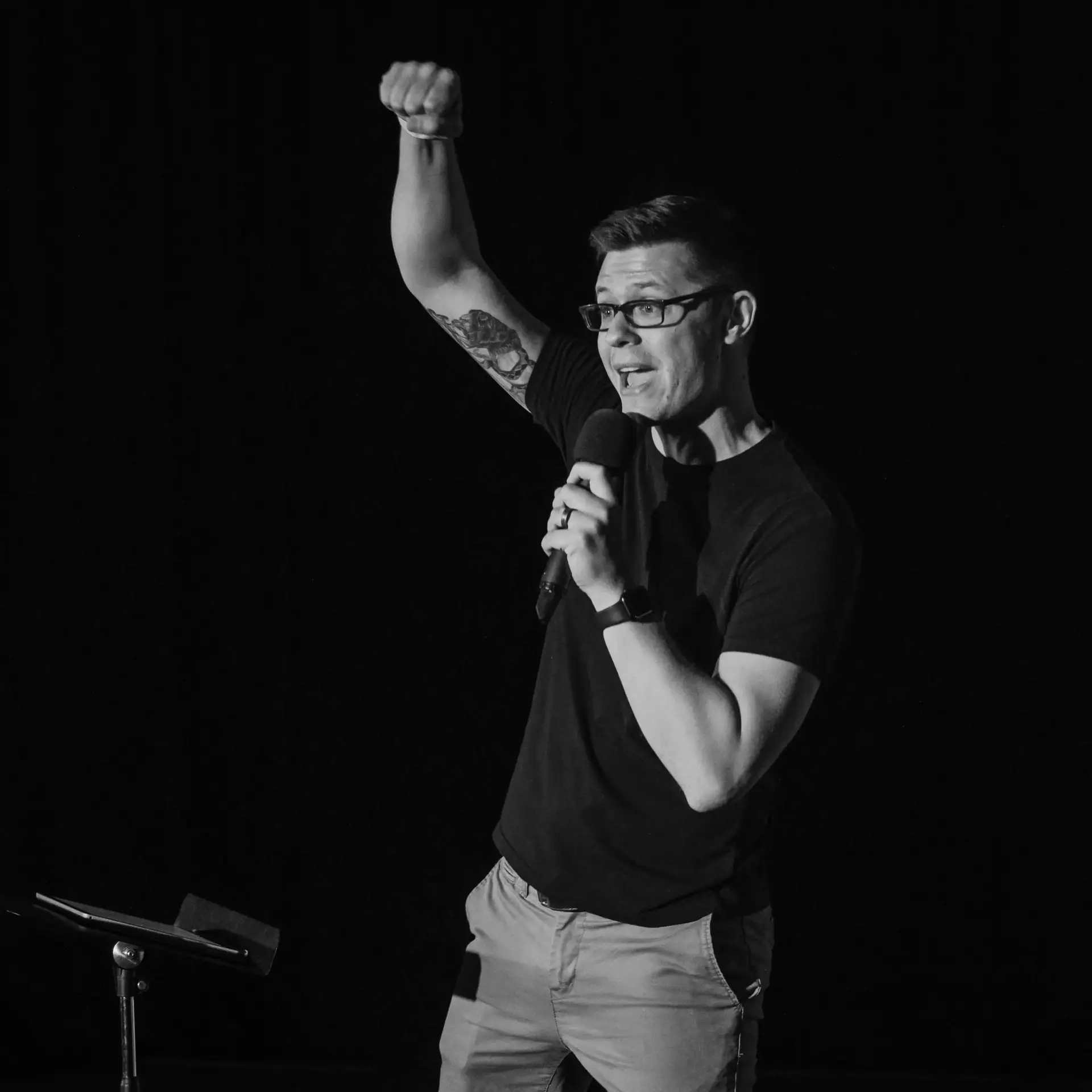 Andrew Steier speaking into microphone at Everyday Faith Podcast event.
