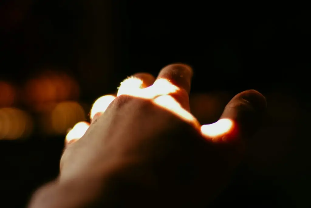 Hand reaching toward light symbolizing faith and hope in Christian life.