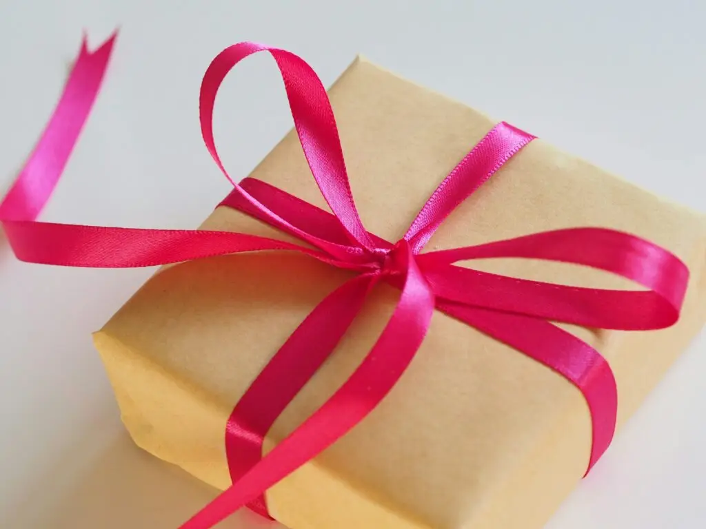 Wrapped gift with pink ribbon, Christian Mother’s Day gift ideas.