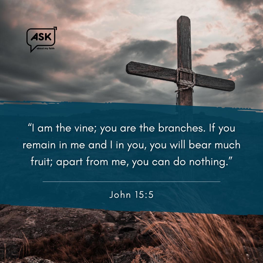 Wooden cross on barren ground, illustrating John 15:5 verse about remaining in Christ.